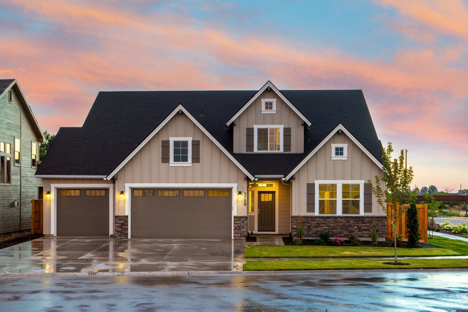 Modern family home glowing at golden-hour dusk with a warm sky