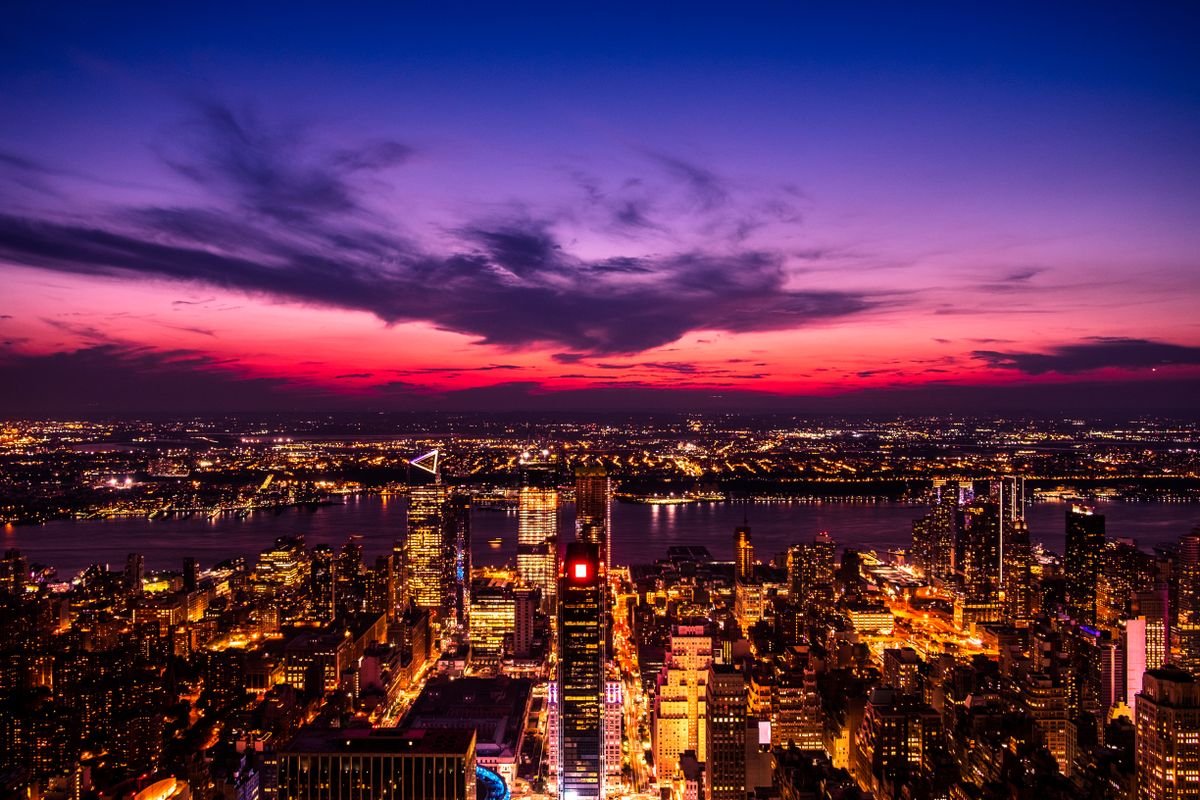 New York City skyline against a dramatic sunset sky