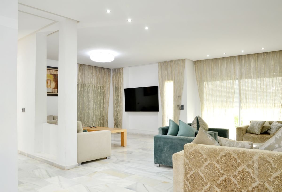 Spacious modern living room with elegant sofas and stylish decor in a premium rental