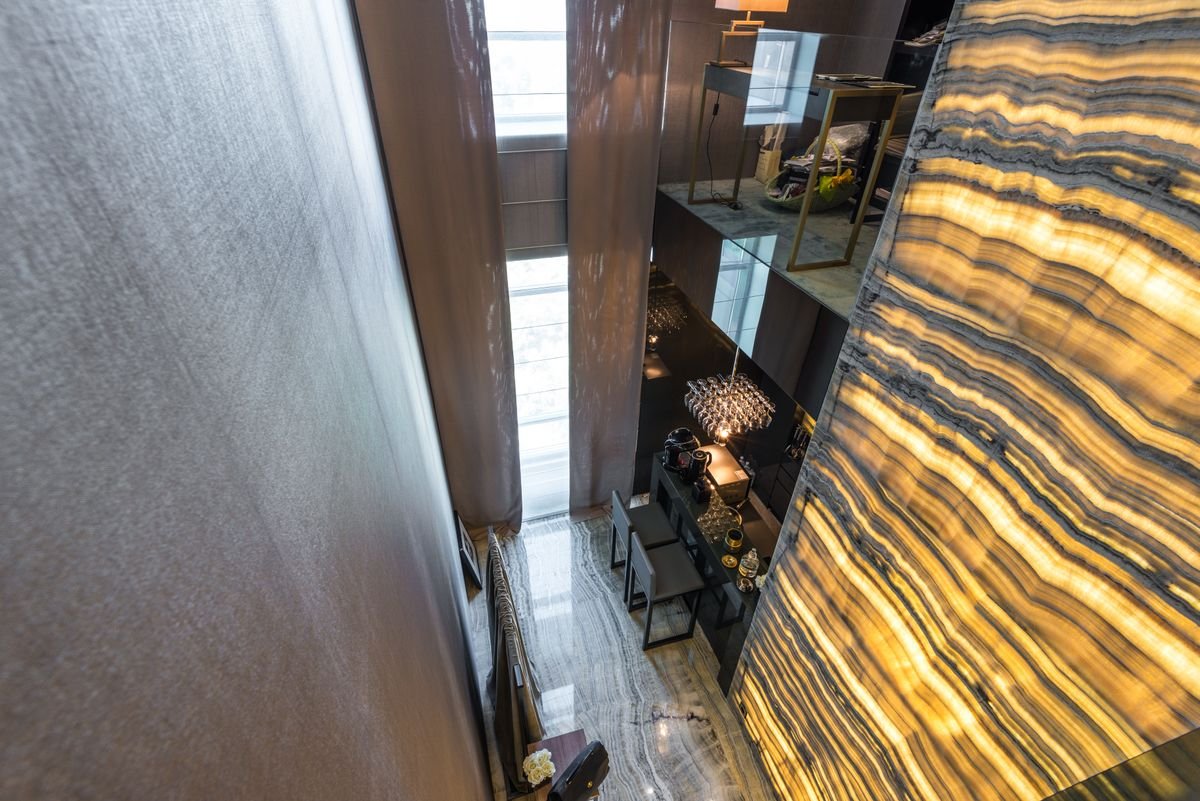 Double-height loft interior with a marble accent wall in a downtown Austin high-rise