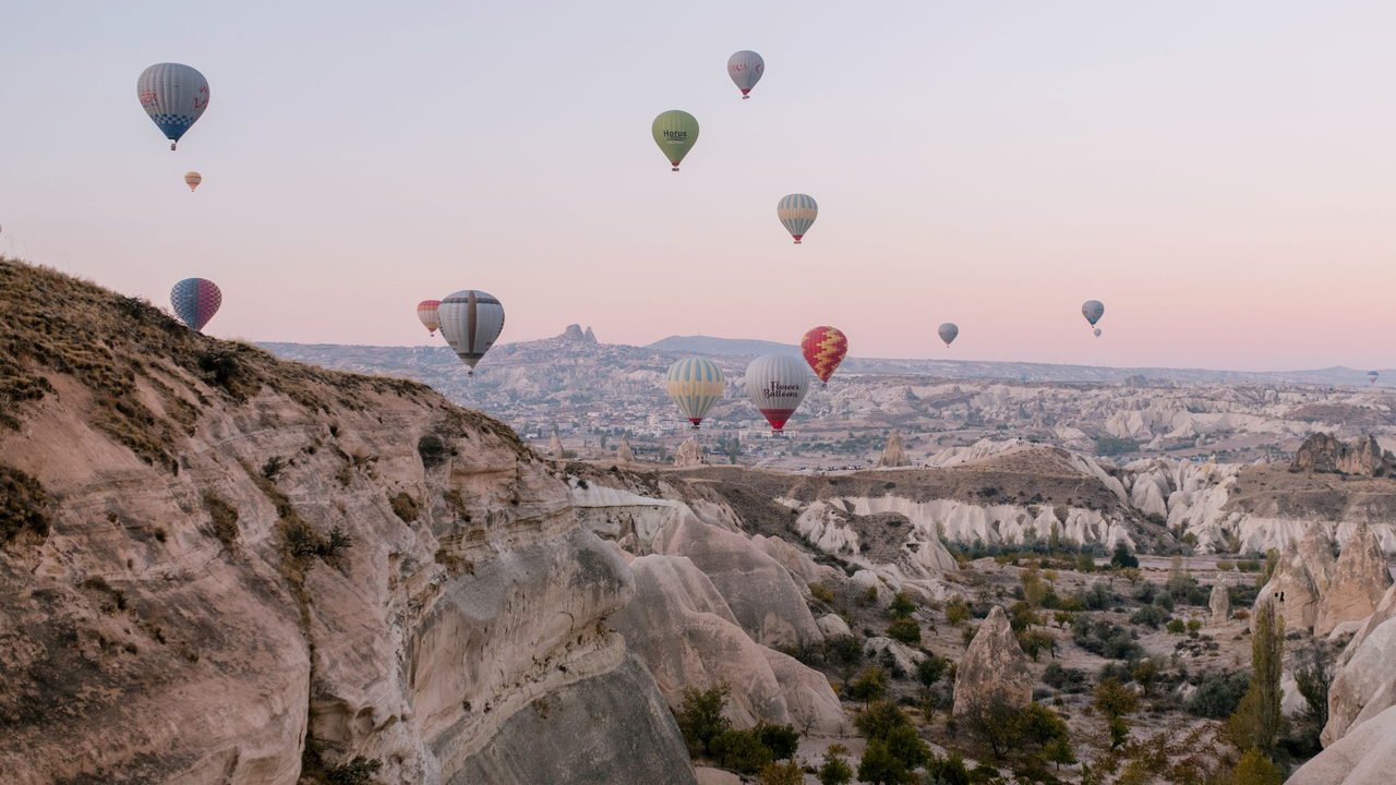 Hot air balloons over the rock formations of Cappadocia, Turkey, at sunrise