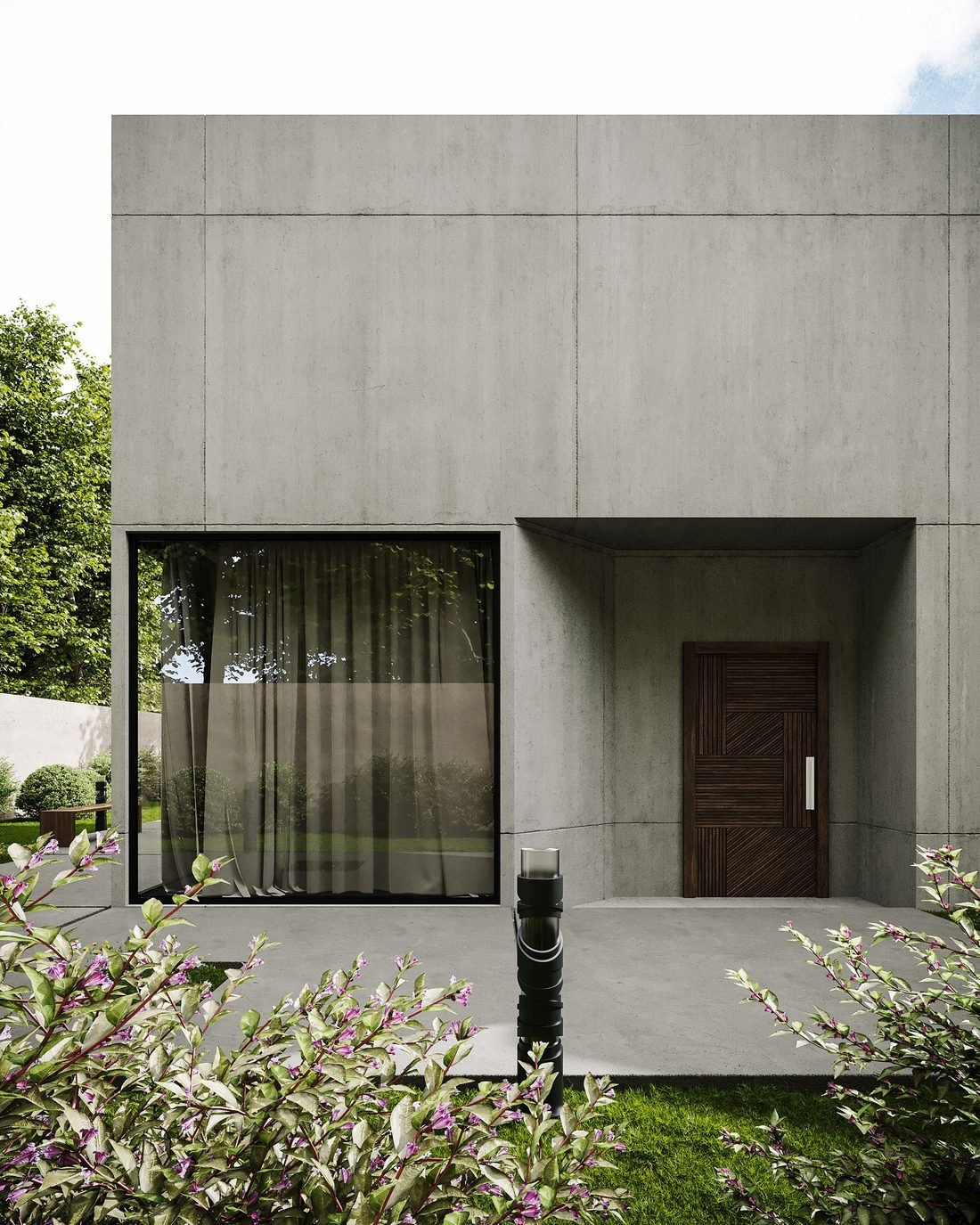 Entrance to a private house: a plain in-situ concrete wall with a deep recess and a solid timber door